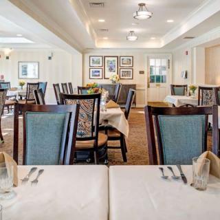 An elegant restaurant dining room with neatly arranged tables and chairs.
