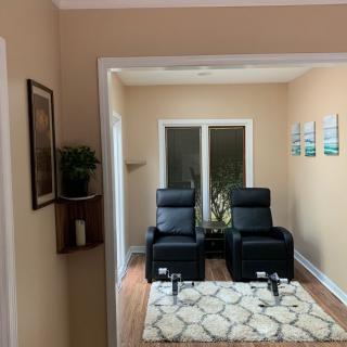 A cozy living room with two recliner chairs and elegant decor.