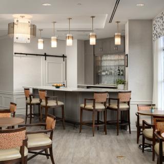 A modern dining area with a bar counter and stylish lighting.