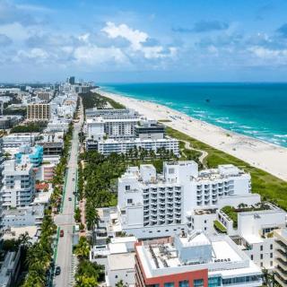 A stunning aerial view of a vibrant coastal city with pristine beaches and clear blue waters.