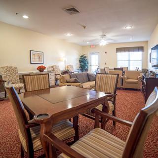 A cozy living room with comfortable seating and a dining table.