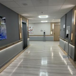 A modern hospital corridor featuring sleek design and ambient lighting.