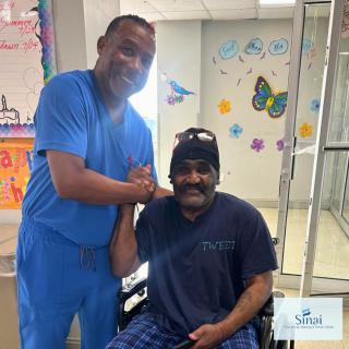 A medical professional and a patient share a positive moment in a healthcare setting.