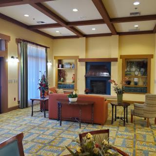 A cozy and inviting lobby area featuring comfortable furniture and warm lighting.