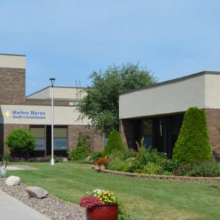 A healthcare facility with a landscaped exterior and modern architecture.