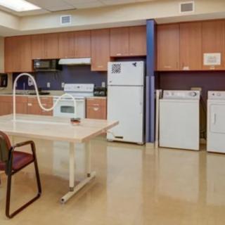 A modern kitchen with appliances and wooden cabinets.