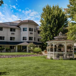 A scenic view of a building with a gazebo and landscaped garden.