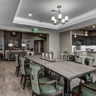 A spacious and elegantly designed dining area featuring modern furniture and stylish lighting.