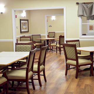 A cozy dining area with neatly arranged tables and chairs.