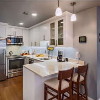 A modern kitchen with sleek appliances and a cozy breakfast bar.