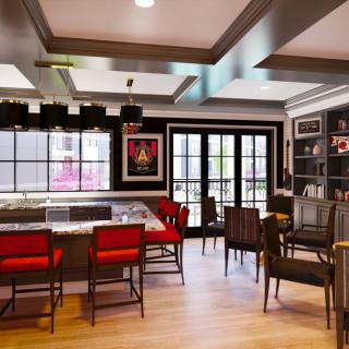 A modern bar interior with red chairs and wood flooring, featuring a seating area and decorative shelving.