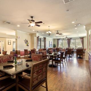 Spacious dining area with elegant setup and abundant natural light.