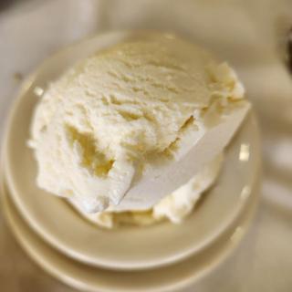 A portion of creamy butter on a plate.