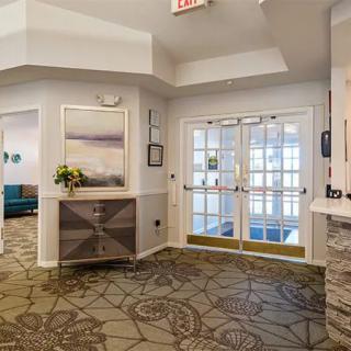 A modern lobby entrance with stylish decor and carpeting.