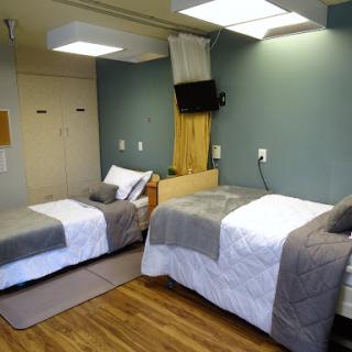 A cozy and modern shared bedroom featuring two neatly made beds.