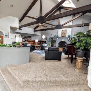 Spacious living area with exposed beams and abundant natural light.