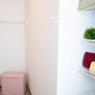 Organized closet space with neatly arranged shelves and a storage box.