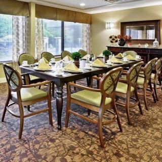 A well-arranged dining room with a set table and elegant decor.