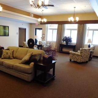 A spacious living room with elegant furnishings and soft lighting.