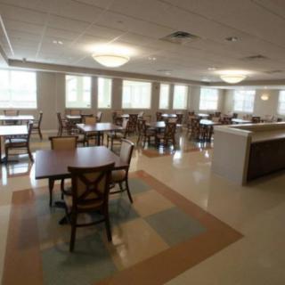 An empty dining area with tables and chairs arranged neatly.