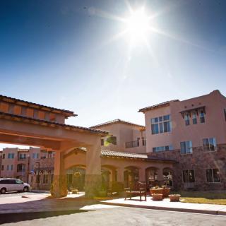 A sunny day at the entrance of a large residential building.