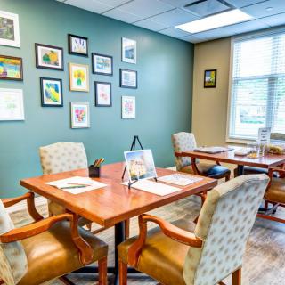 A well-decorated office meeting room with wall art and natural lighting.