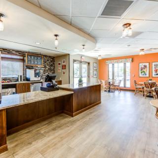 A modern lobby with a reception desk and seating area.