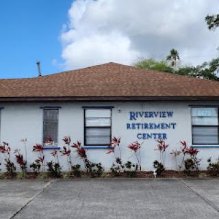 View of the Riverview Retirement Center, featuring vibrant floral arrangements in front.