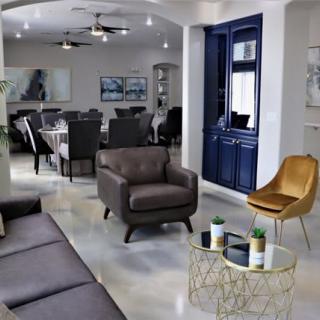A modern living room with sleek furniture and a dining area in the background.
