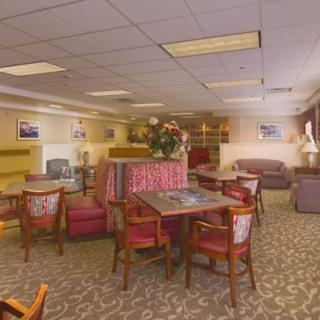A cozy lounge area with tables, chairs, and couches arranged for relaxation.
