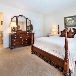 A beautifully arranged classic-style bedroom with elegant furniture and a cozy atmosphere.