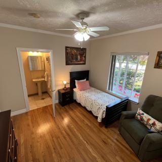 Cozy bedroom with a single bed and direct access to a bathroom.