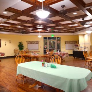A cozy dining area featuring wooden accents and a green tablecloth, perfect for gatherings.