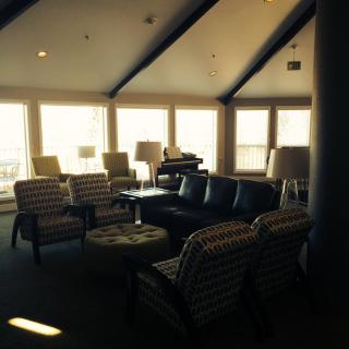 A cozy living room with ample seating and large windows allowing natural light.