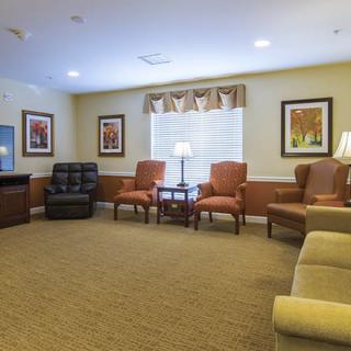 A cozy living room with comfortable seating and warm lighting.