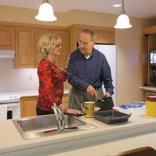 A couple preparing a meal together in the kitchen.