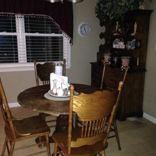 A cozy dining room with a wooden table and chairs near a window.