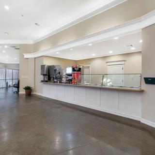 A modern reception area with a sleek desk and bright lighting.