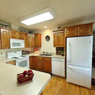 A cozy kitchen with wooden cabinets and modern appliances.