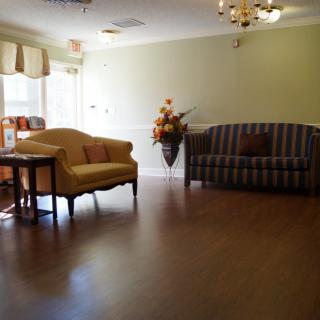 A cozy living room with elegant furniture and wooden flooring.
