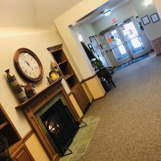 A cozy lobby area with a fireplace and decorative elements.