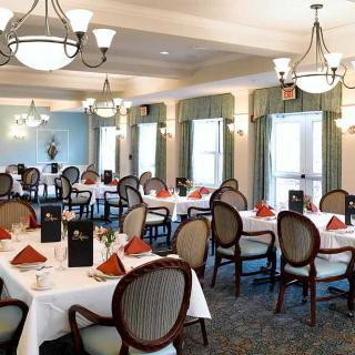 An elegantly decorated dining room with neatly arranged tables and chairs.