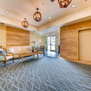 A modern lobby with comfortable seating and decorative lighting.