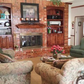 Cozy living room with a brick fireplace and comfortable seating.