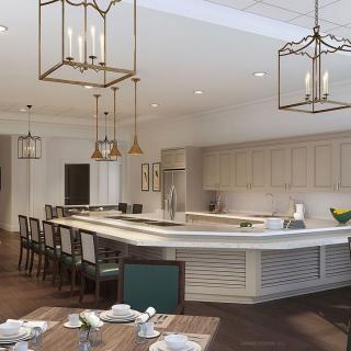 A modern kitchen with a large island, surrounded by bar stools and illuminated by pendant lighting.
