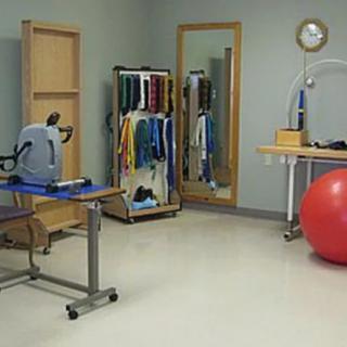 A physical therapy room equipped with various rehabilitation and exercise tools.