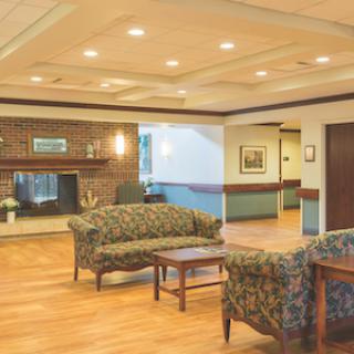 A cozy lobby area featuring comfortable sofas and a warm fireplace, perfect for relaxation.