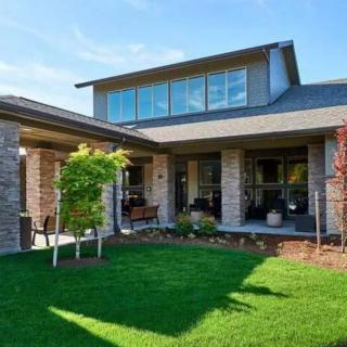 A modern house with a well-maintained lawn and garden.