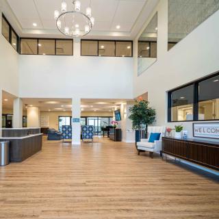 A spacious and modern lobby with elegant interior design, featuring a reception desk and comfortable seating.