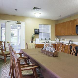 A cozy kitchen and dining area with wooden furniture and cabinets.